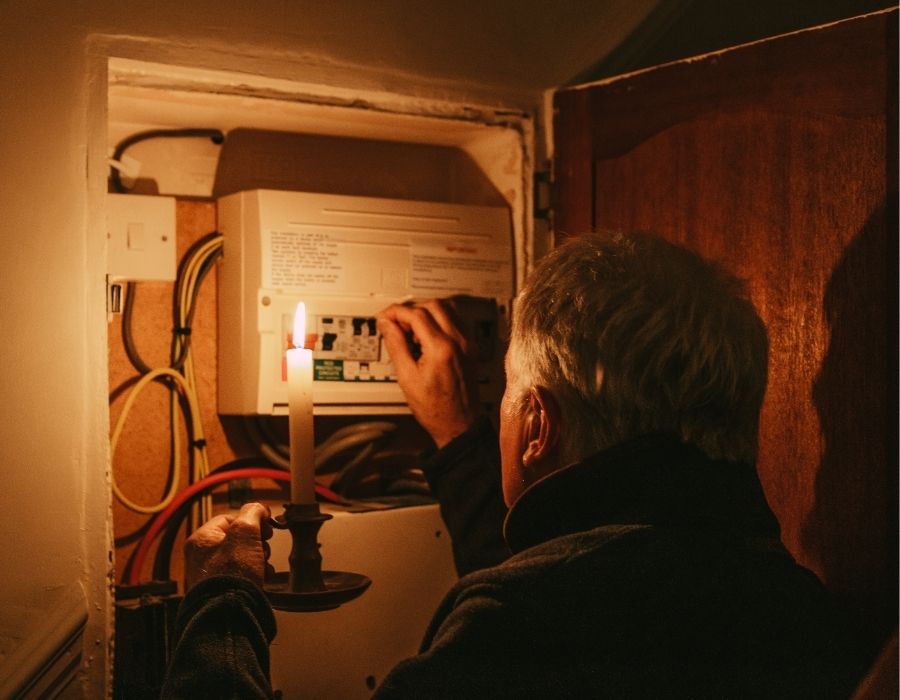 homeowner checking home fuse box